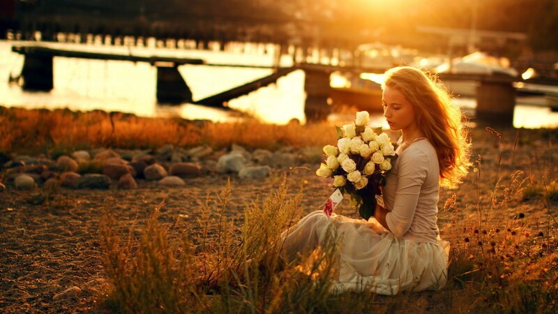 woman with flowers at sunset
