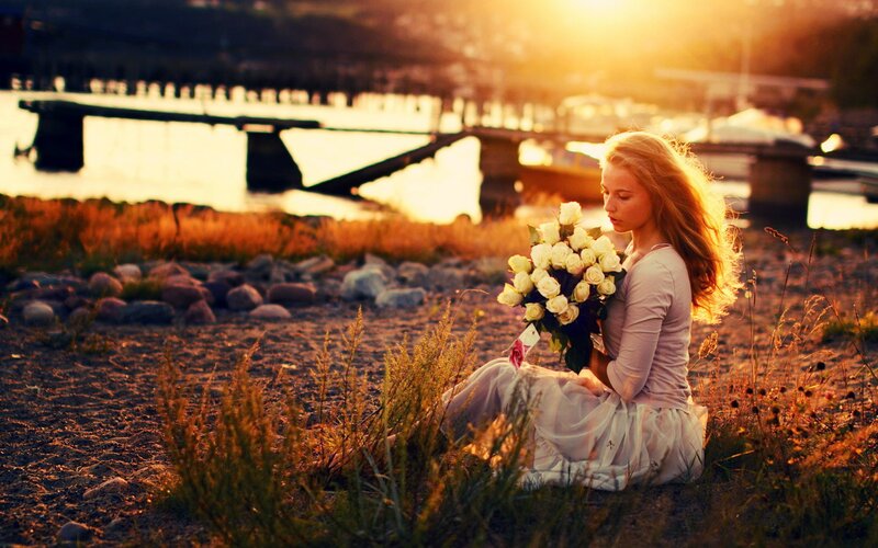 woman with flowers at sunset