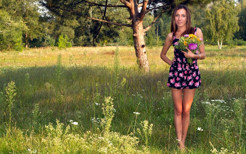 Woman with flowers in a field