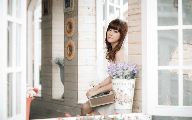 woman with flowers in a wooden house