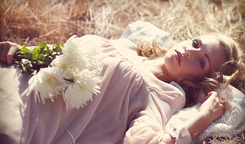 Woman with flowers in field