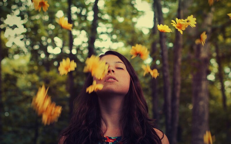 woman with flowers in forest