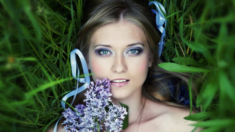 woman with flowers in grass