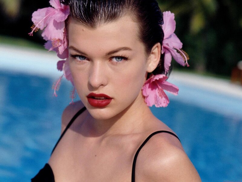 woman with flowers in hair by pool