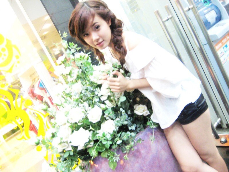 woman with flowers in store