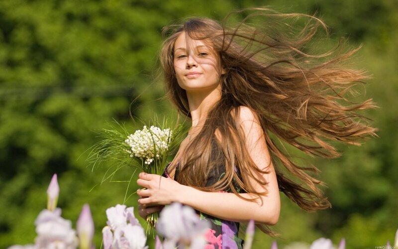 woman with flowers in wind