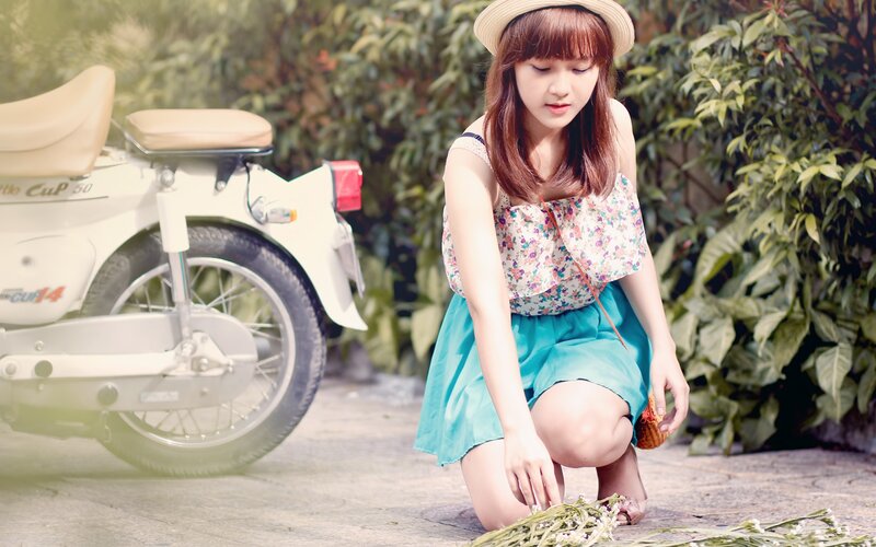 Woman with flowers near motorcycle