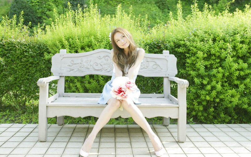Woman with flowers on a bench