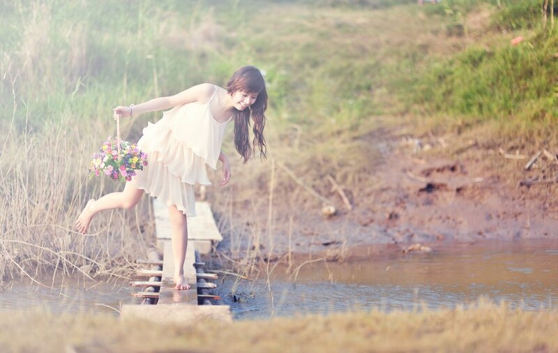 Woman with flowers on a bridge