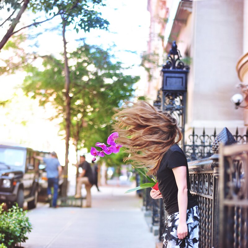 Woman with flowers on a city street