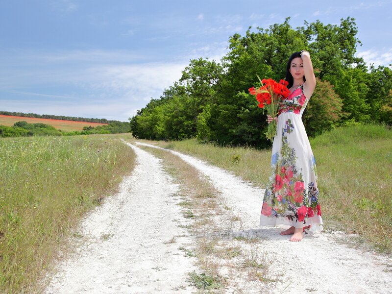 Woman with flowers on a country path