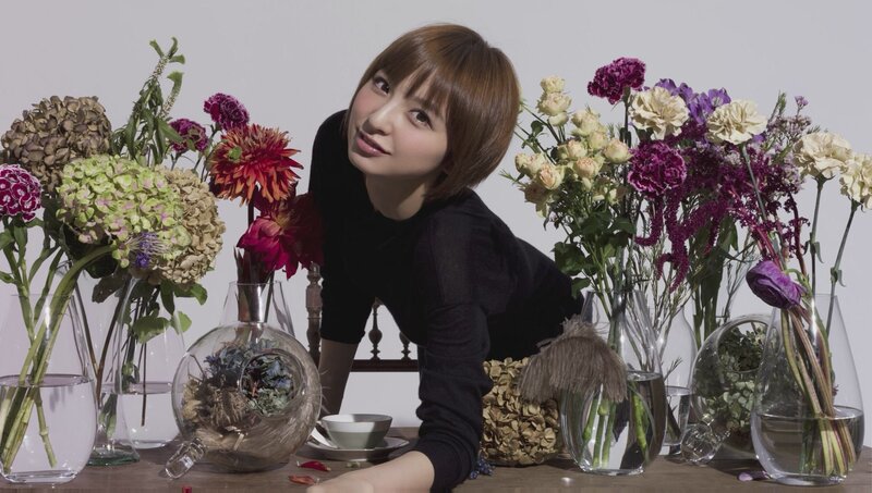 woman with flowers on a table