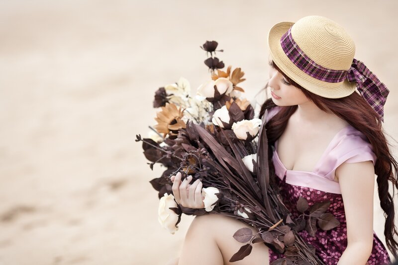 woman with flowers on beach