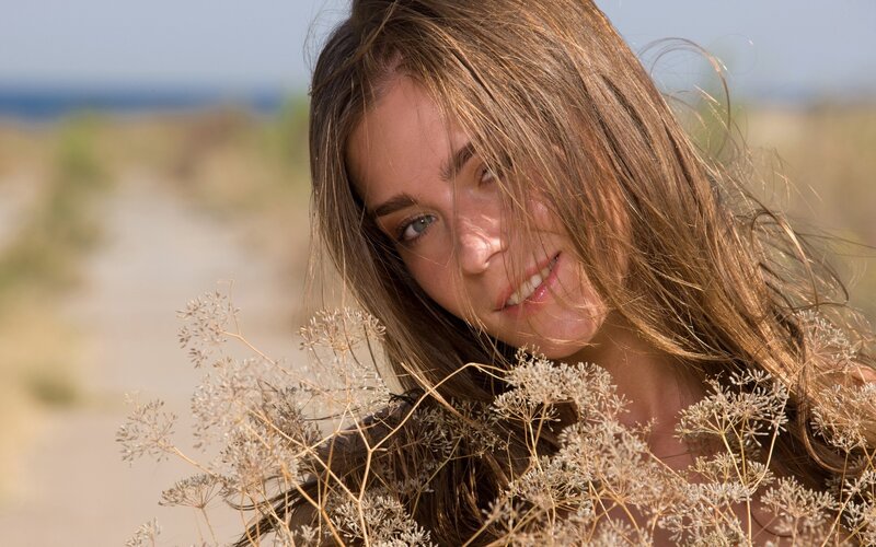 woman with flowers on beach
