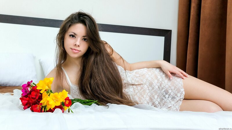 woman with flowers on bed