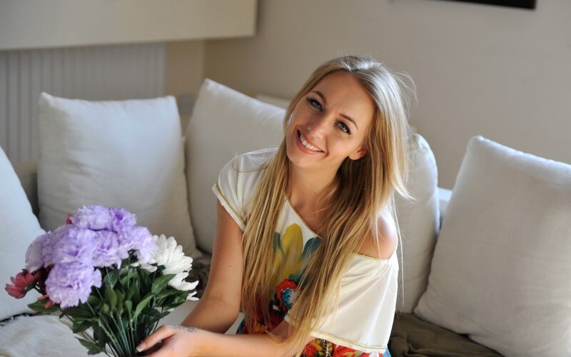 woman with flowers on couch