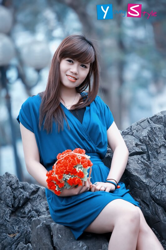 Woman with flowers on rocks