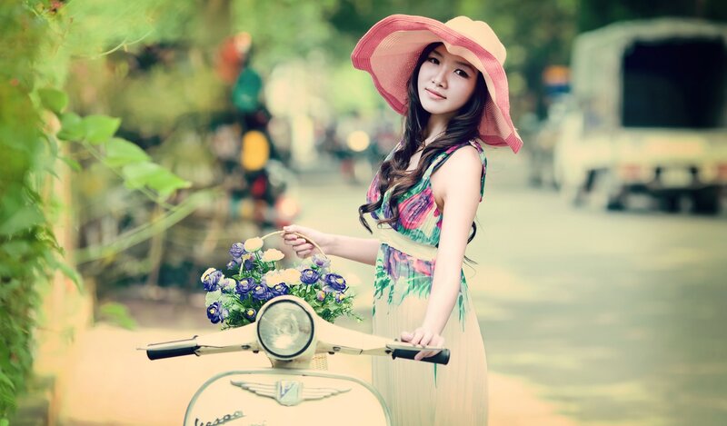 Woman with flowers on scooter