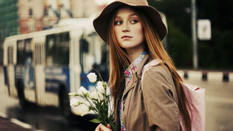 woman with flowers on street