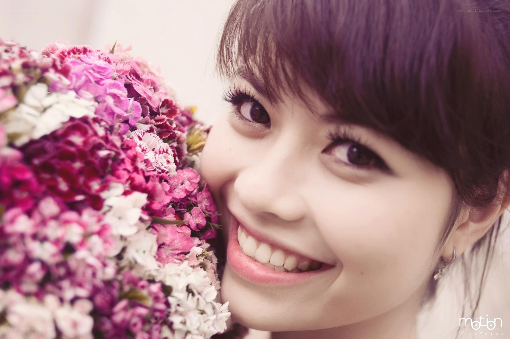 woman with flowers smiling
