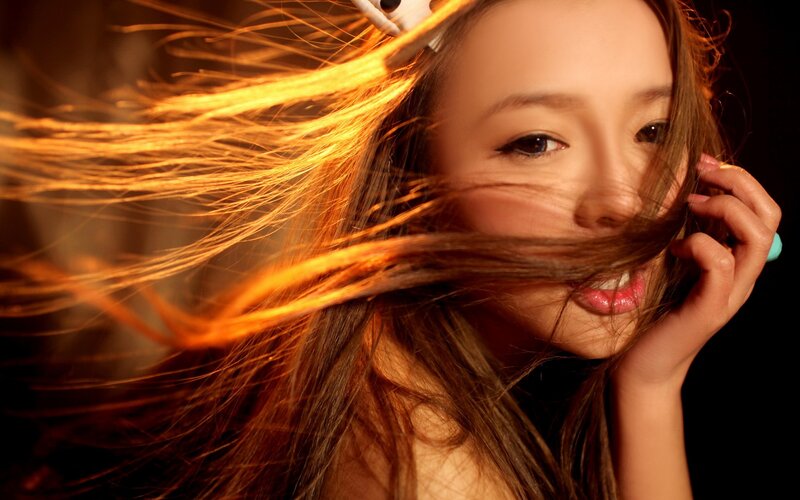 woman with flowing hair in golden light