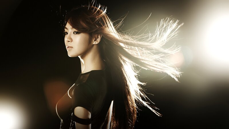 woman with flowing hair in spotlight