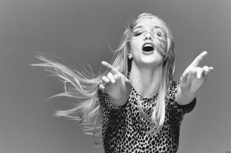 woman with flowing hair pointing
