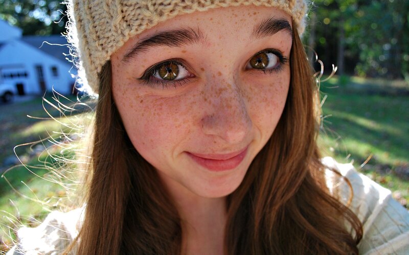woman with freckles and beanie