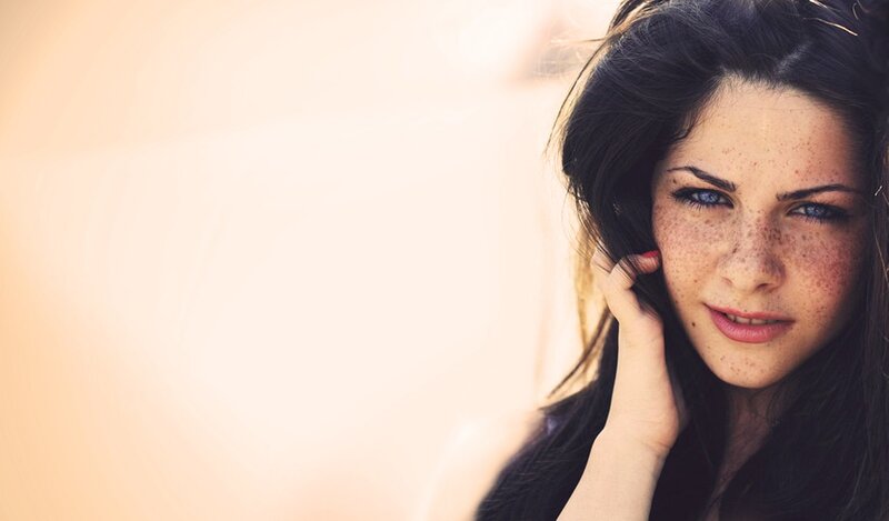 woman with freckles and blue eyes