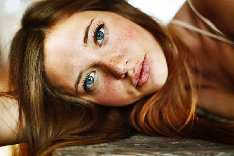 woman with freckles and blue eyes