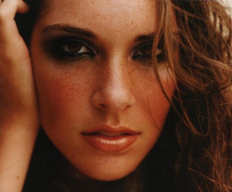 woman with freckles and dark eyes
