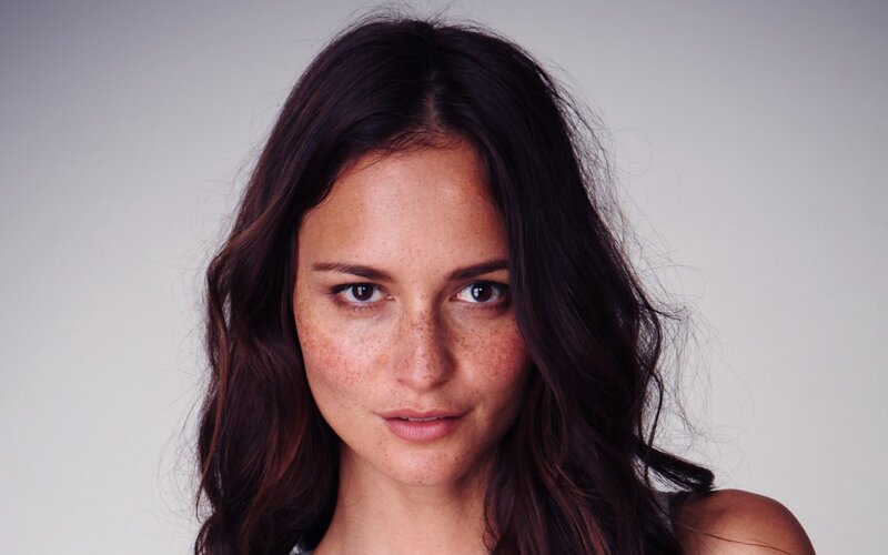 woman with freckles and dark hair