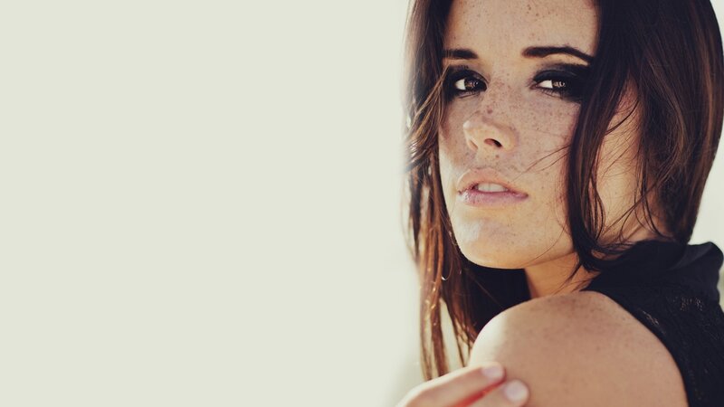 woman with freckles and dark makeup