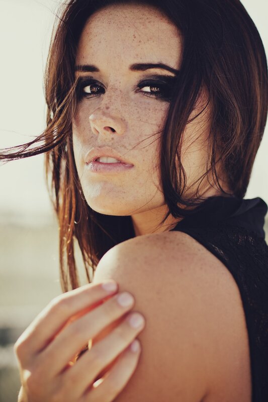 woman with freckles and dark makeup