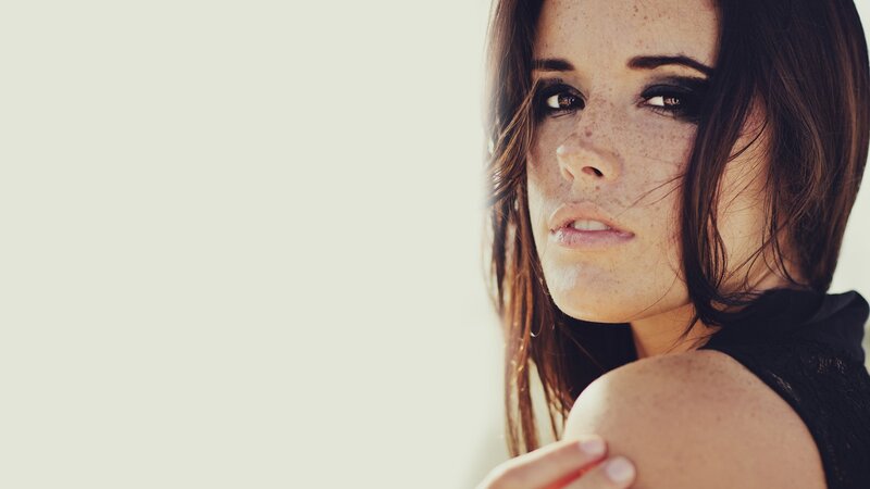 woman with freckles and dark makeup