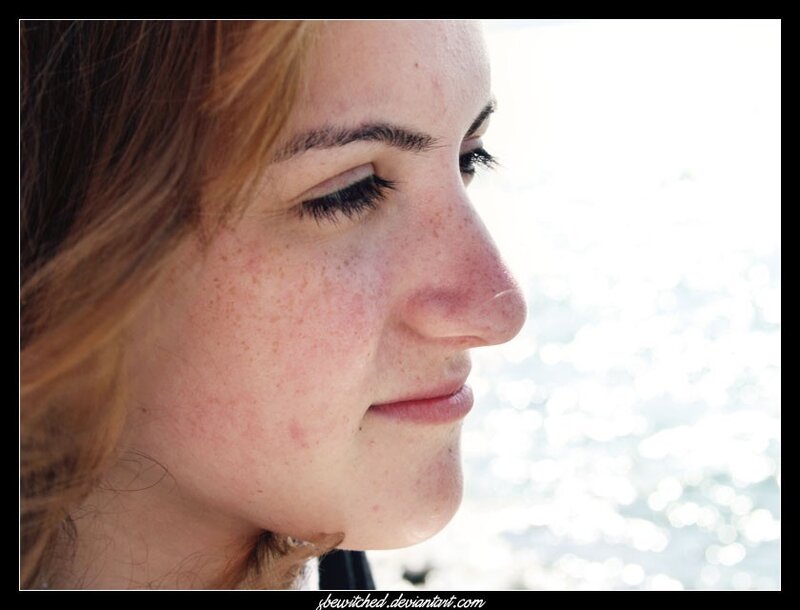 woman with freckles by water