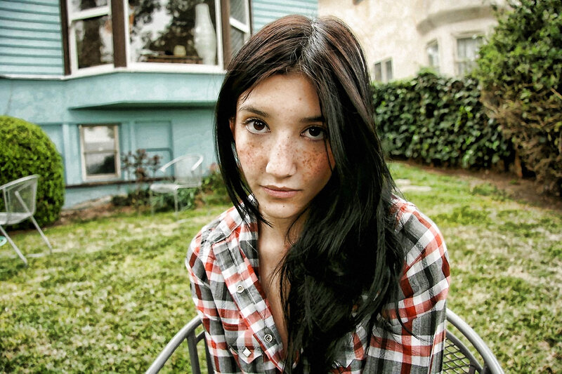 woman with freckles in backyard