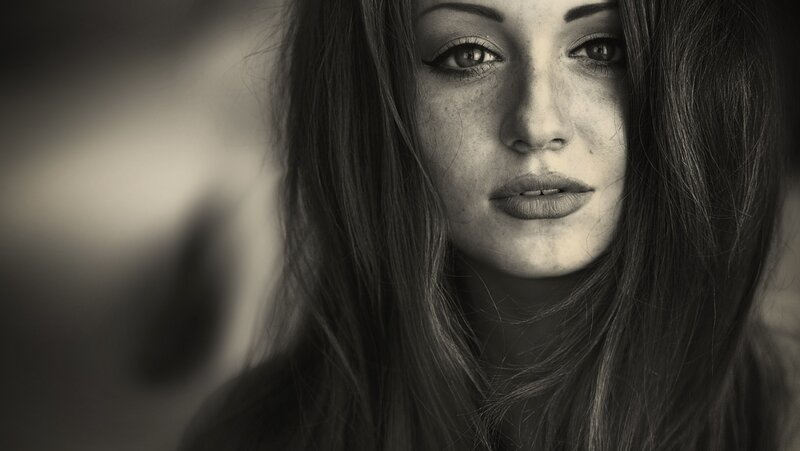 woman with freckles in black and white