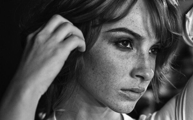 woman with freckles in black and white