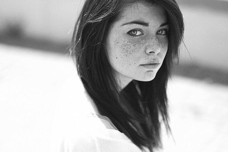 woman with freckles in black and white