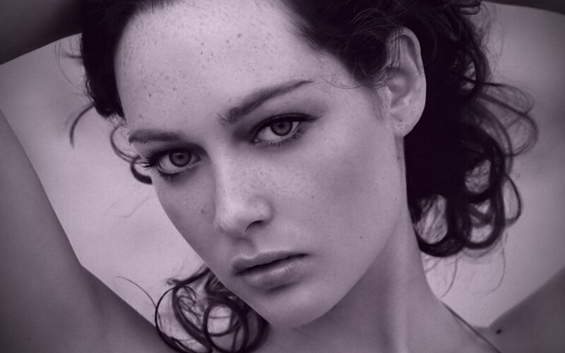 woman with freckles in black and white