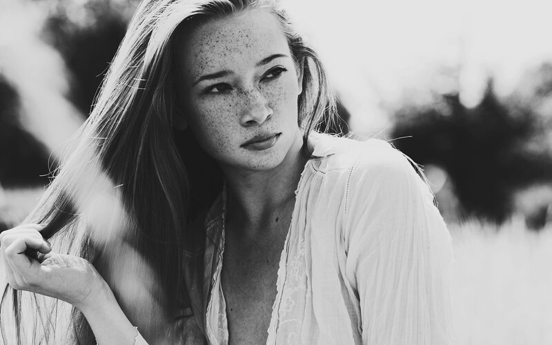 woman with freckles in black and white