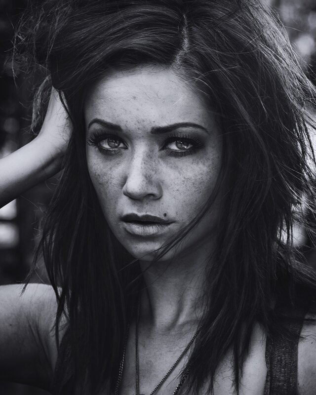 woman with freckles in black and white