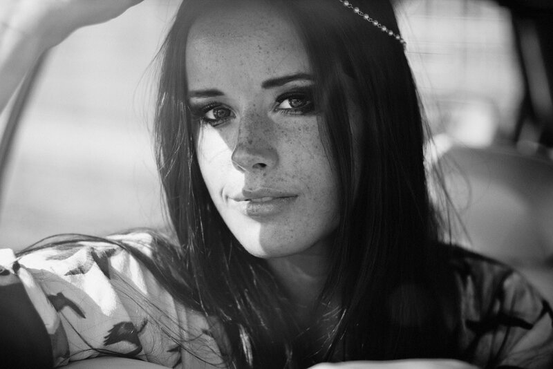 woman with freckles in car