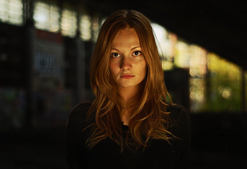 woman with freckles in dim light