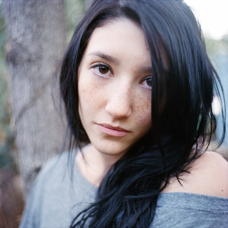 woman with freckles in forest