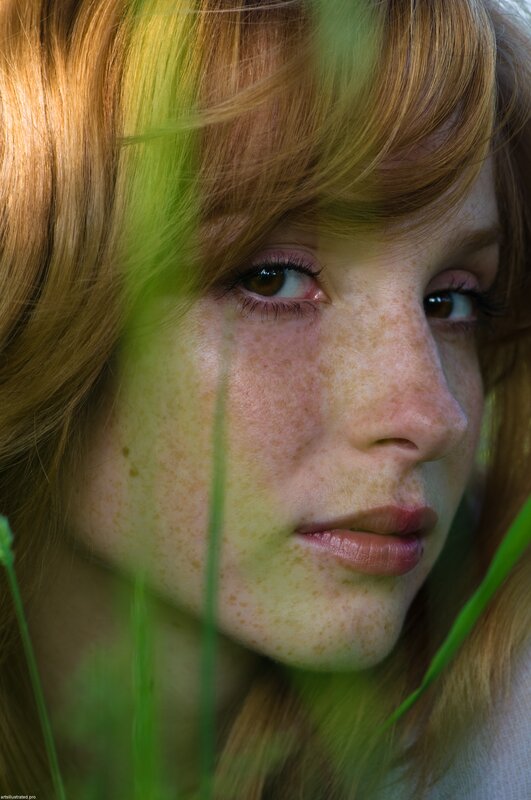 woman with freckles in grass