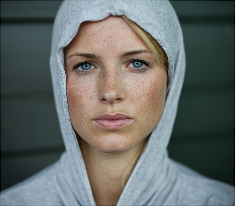woman with freckles in hoodie