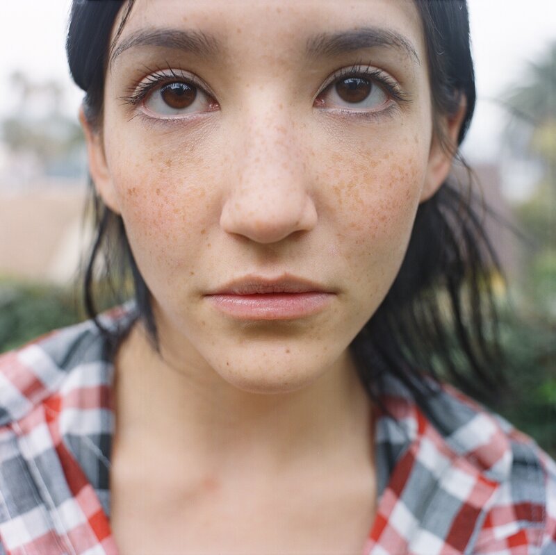 woman with freckles in plaid shirt