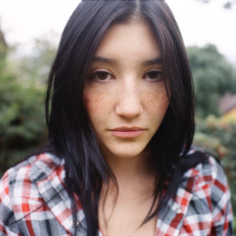 woman with freckles in plaid shirt